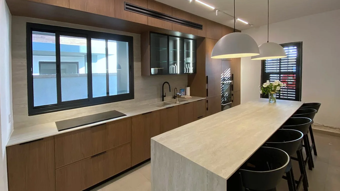 Real kitchen with Delgado slim shaker fronts in warm woodgrain and an island
